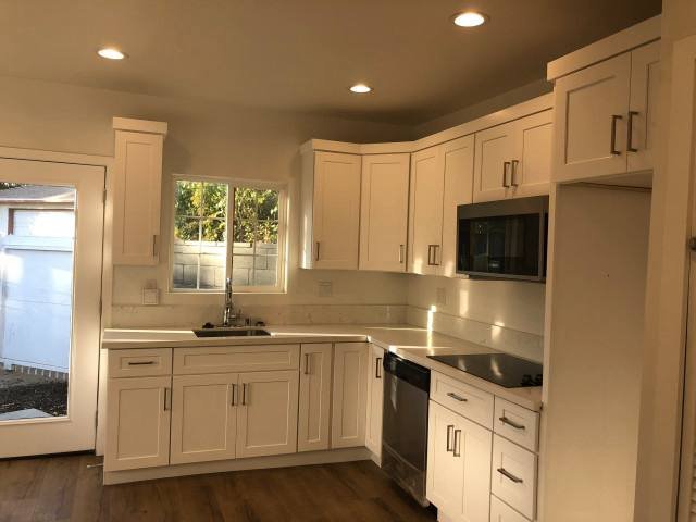 Finished white shaker kitchen cabinets with stainless appliances